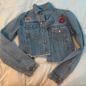 Forever 21 jean jacket with sewed flowers on front and back.
